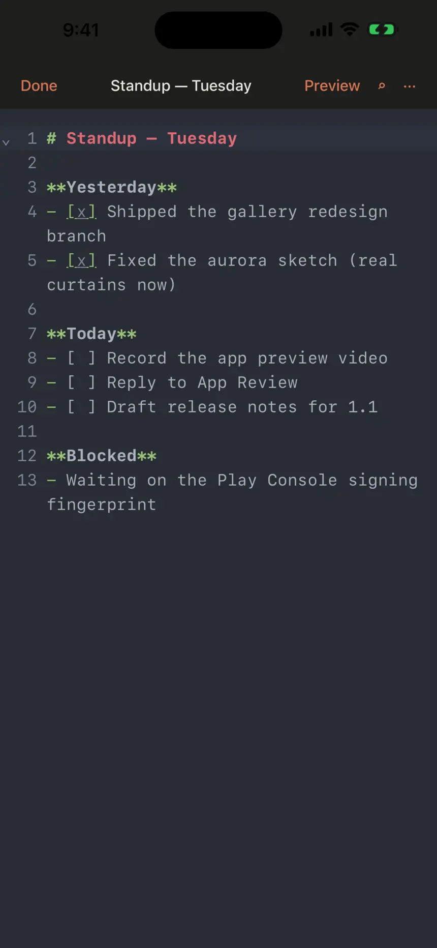 A Markdown standup note open in the Carets editor with line numbers, coloured headings and tap-to-toggle checklists.
